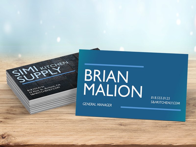 Printed business cards on a wood table