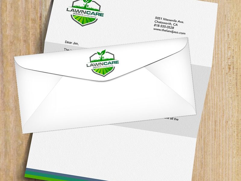 Printed letterhead and matching envelope on a wood table